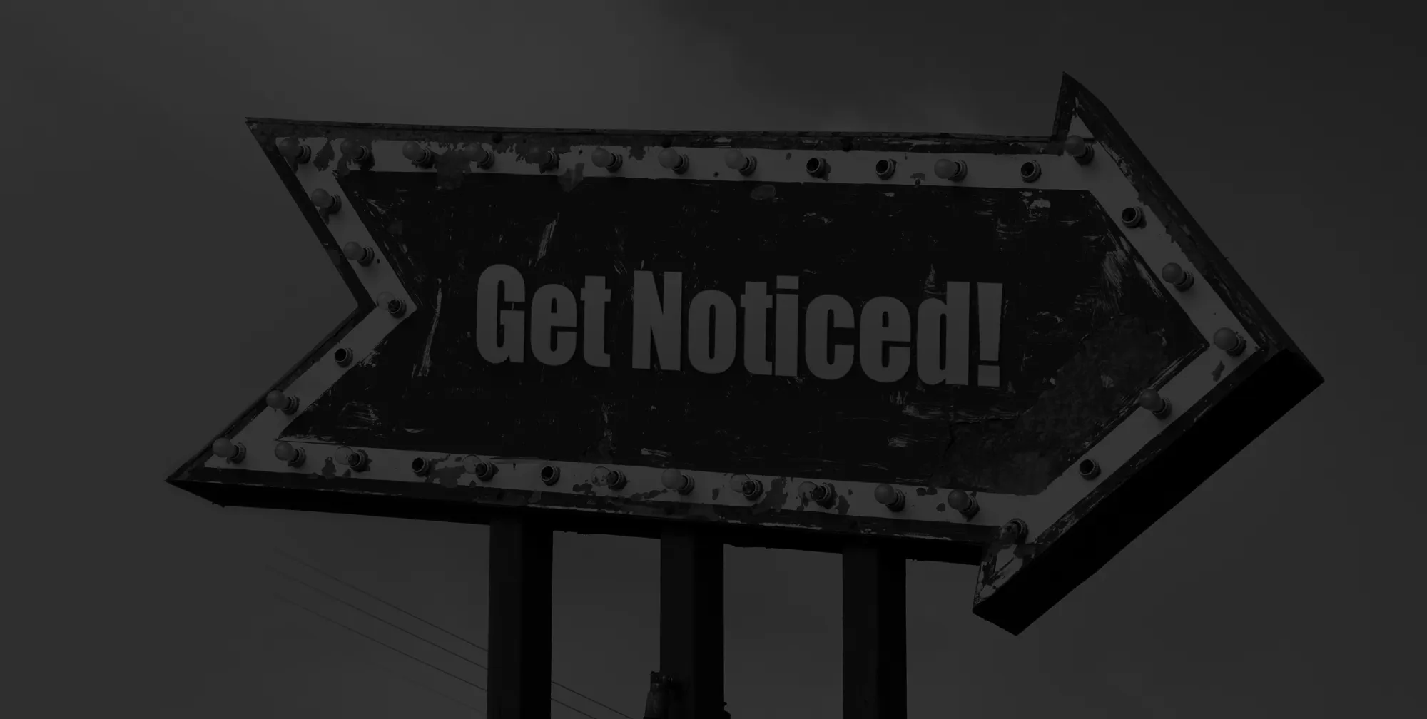 A sign shaped liked an arrow that says Get Noticed